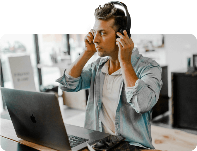 man standing in front of a laptop getting ready to record content